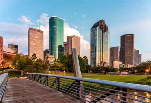 A landscape of several tall buildings with a bridge in the foreground