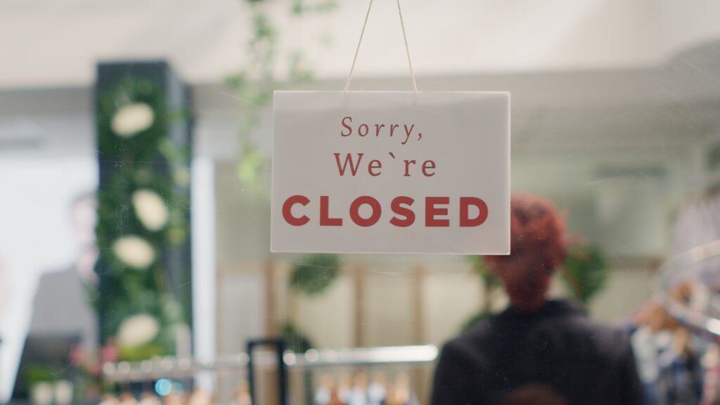 Worker closing down store in order to do restocking in elegant high end fashion boutique.